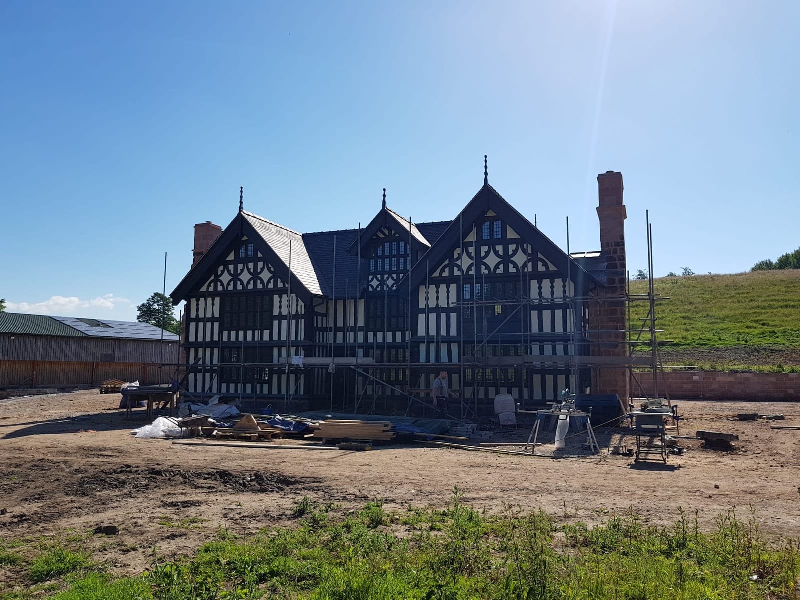 Restored black-and-white oak-framed building in Congleton with sandstone chimneys