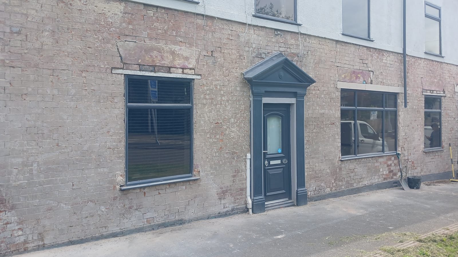 Damaged Tyrolean render stripped back to brick on the Oldham property