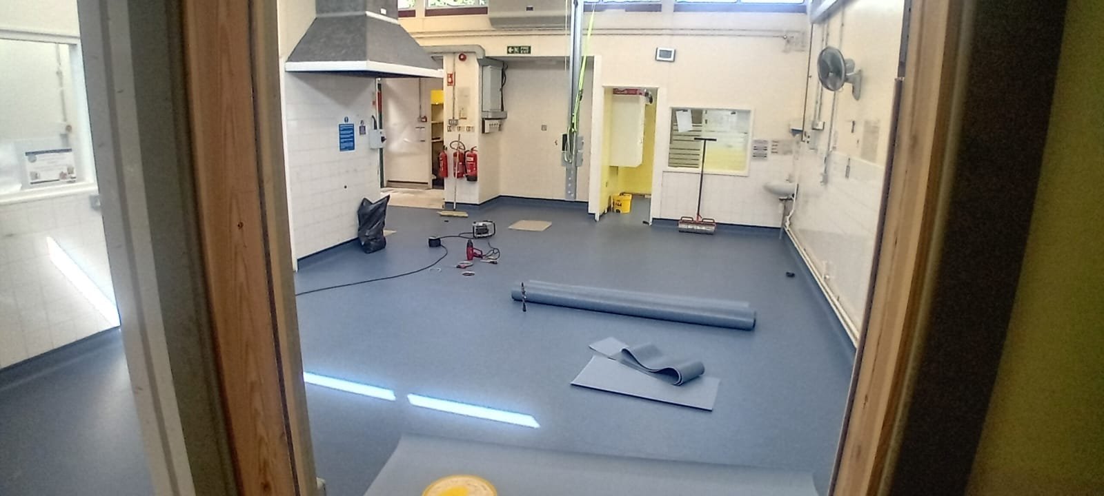 New Polyflor anti-slip safety flooring being laid in the school kitchen