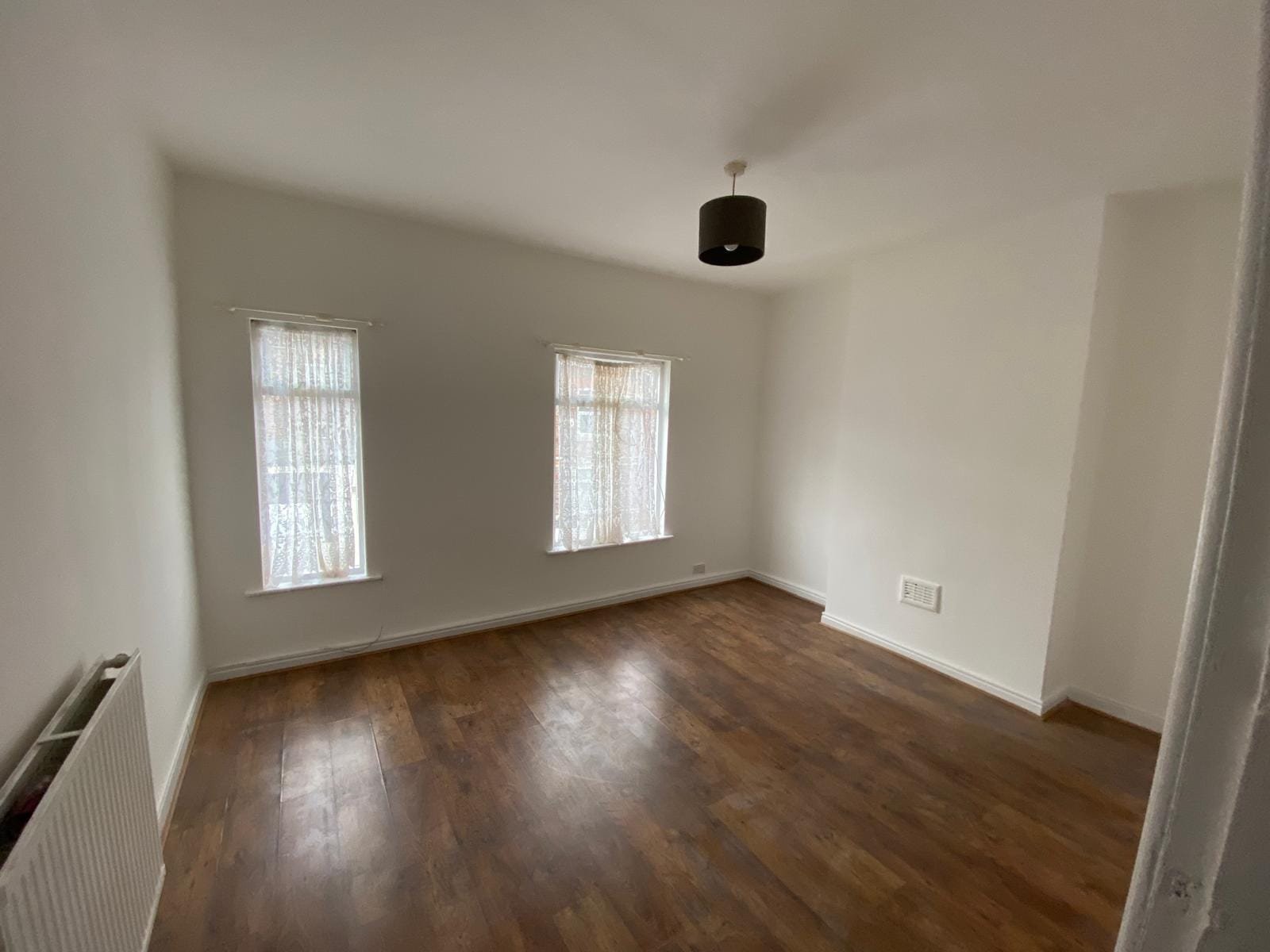 Refurbished room with new flooring and fresh decoration